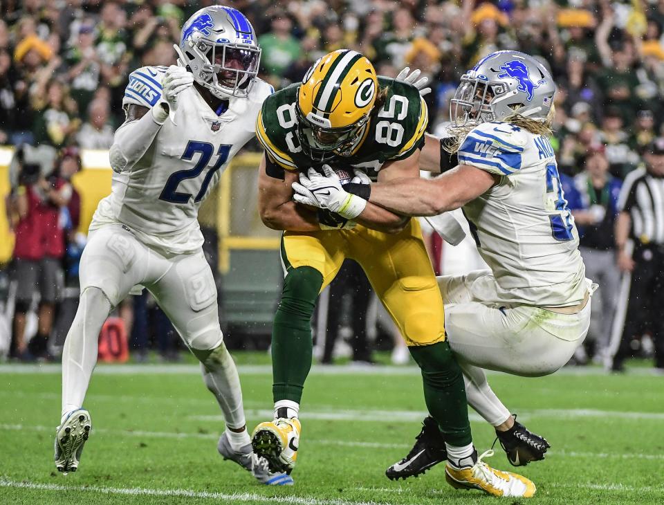 Packers tight end Robert Tonyan catches a pass against Lions safety Tracy Walker III, left, and linebacker Alex Anzalone to score a touchdown in the third quarter of the Lions' 35-17 loss on Monday, Sept. 20, 2021, in Green Bay, Wisconsin.