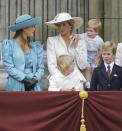 Sarah Ferguson donned eighties power shoulders and leather gloves on the Buckingham Palace balcony in 1987 while sister-in-law, Princess Diana, donned head-to-toe pink. (Getty Images)