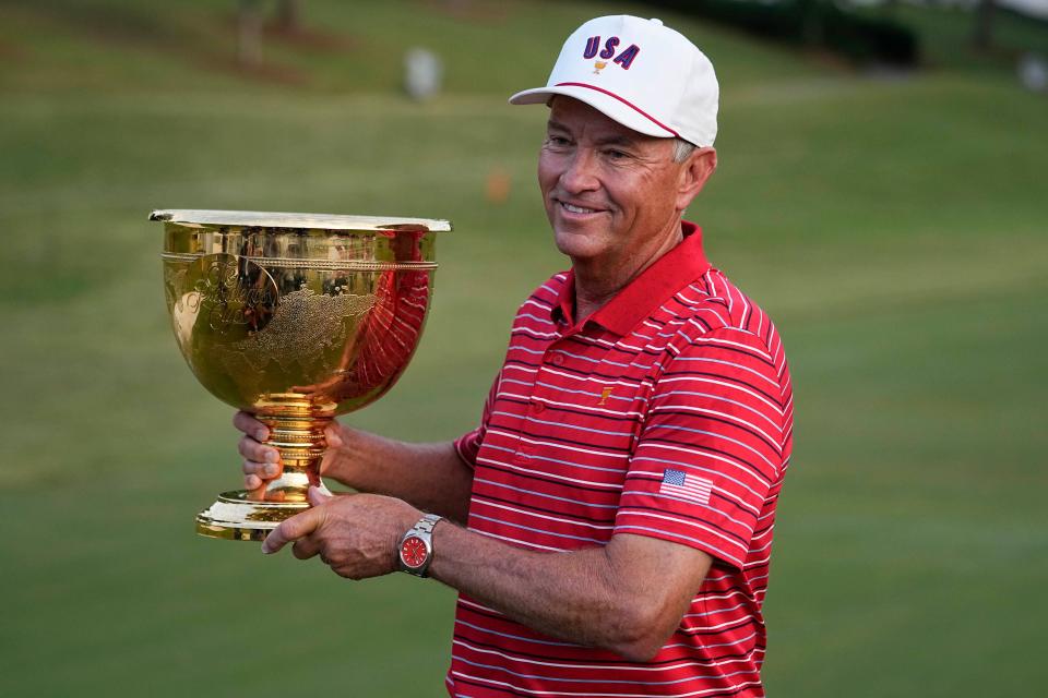 Davis Love III, holding the trophy for the U.S. team victory in the 2022 Presidents Cup, has hosted the RSM Classic for its 14-year history.