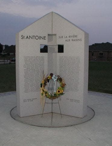 This photo shows the second St. Antoine Burial Ground Monument near the original burial ground and church site off N. Custer Rd.  This monument was dedicated in 2000.