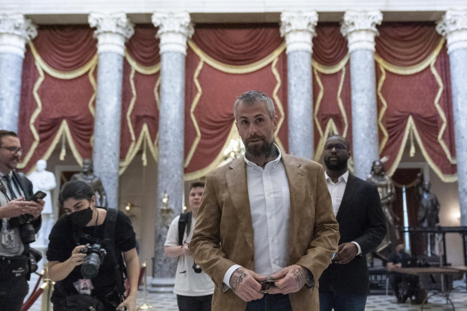 Former Washington Metropolitan Police Department officer Michael Fanone, center, walks through Statuary Hall as the House meets for a second day to elect a speaker and convene the 118th Congress in Washington, Wednesday, Jan. 4, 2023. (AP Photo/Alex Brandon)