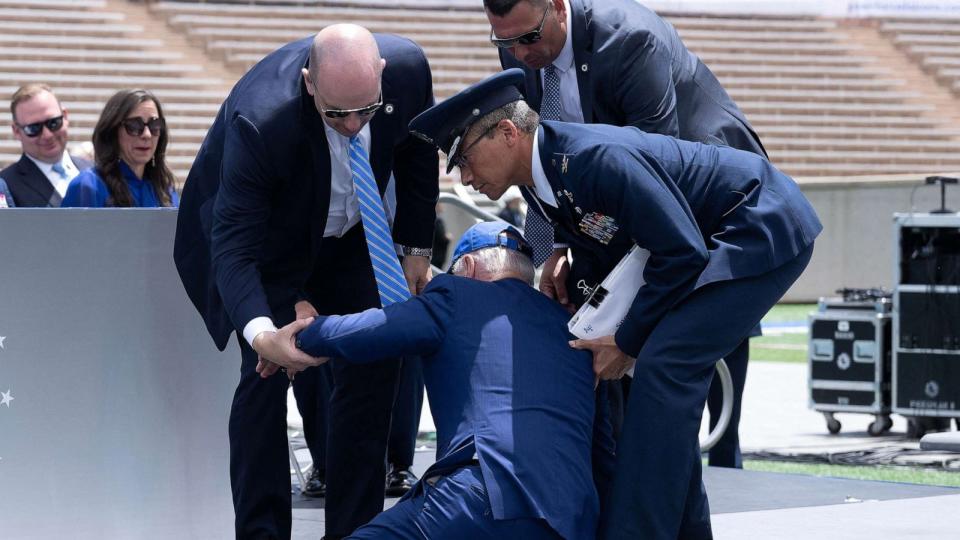 PHOTO: In this June 1, 2023, file photo, President Joe Biden is helped up after falling during the graduation ceremony at the United States Air Force Academy, just north of Colorado Springs in El Paso County, Colorado. (Brendan Smialowski/AFP via Getty Images, FILE)