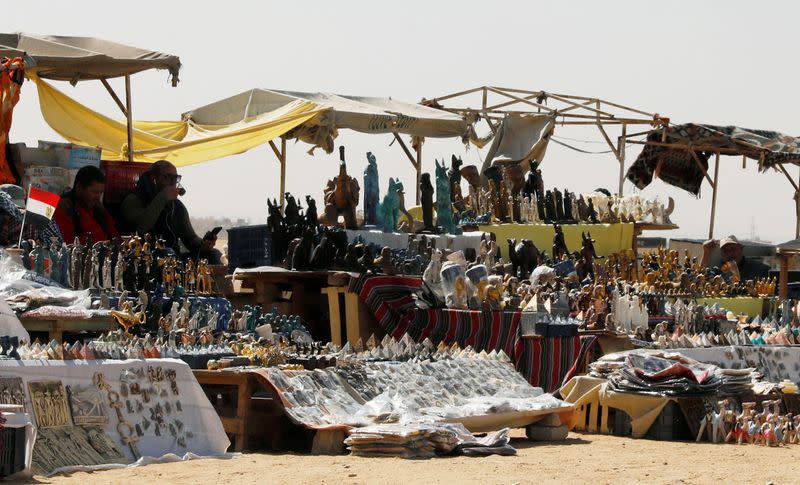 Souvenir vendors wait for tourists at the Great Pyramids of Giza, on the outskirts of Cairo