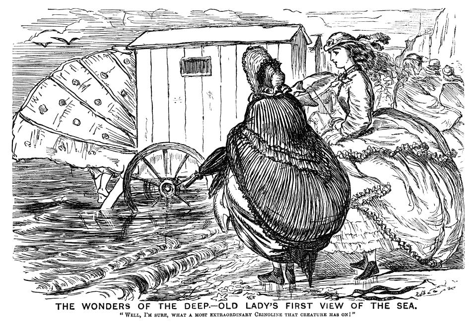 An old lady, visiting the seaside for the first time, is surprised by a bathing machine and its modesty shield. From a bound volume of copies of <em>Punch Almanack</em> for 1865-79. (Getty Images)