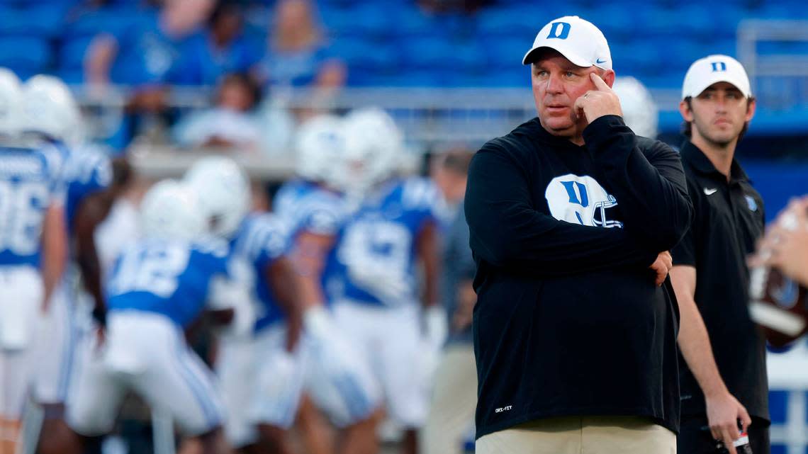 Duke head coach Mike Elko watches as the Blue Devils warm up prior to their season opener against Temple at Wallace Wade Stadium on Friday, Sept. 2, 2022, in Durham, N.C.