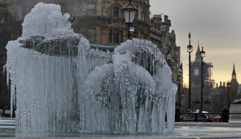 Icicles on the fountain in Trafalgar Square with the background of Big Ben as temperatures dropped below freezing overnight in London, Thursday, Feb. 11, 2021. (AP Photo/Kirsty Wigglesworth)