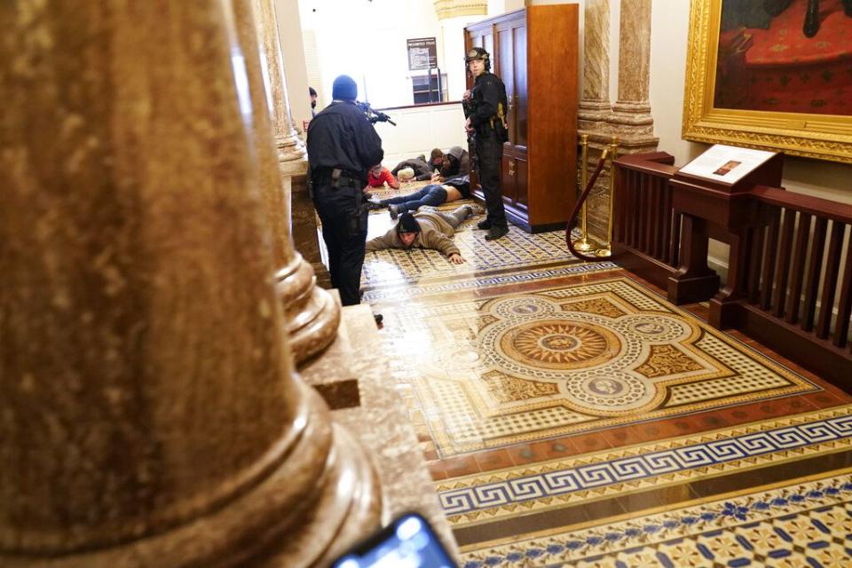 U.S. Capitol Police hold protesters at gun-point near the House Chamber inside the U.S. Capitol on Wednesday, Jan. 6, 2021, in Washington. (AP Photo/Andrew Harnik)