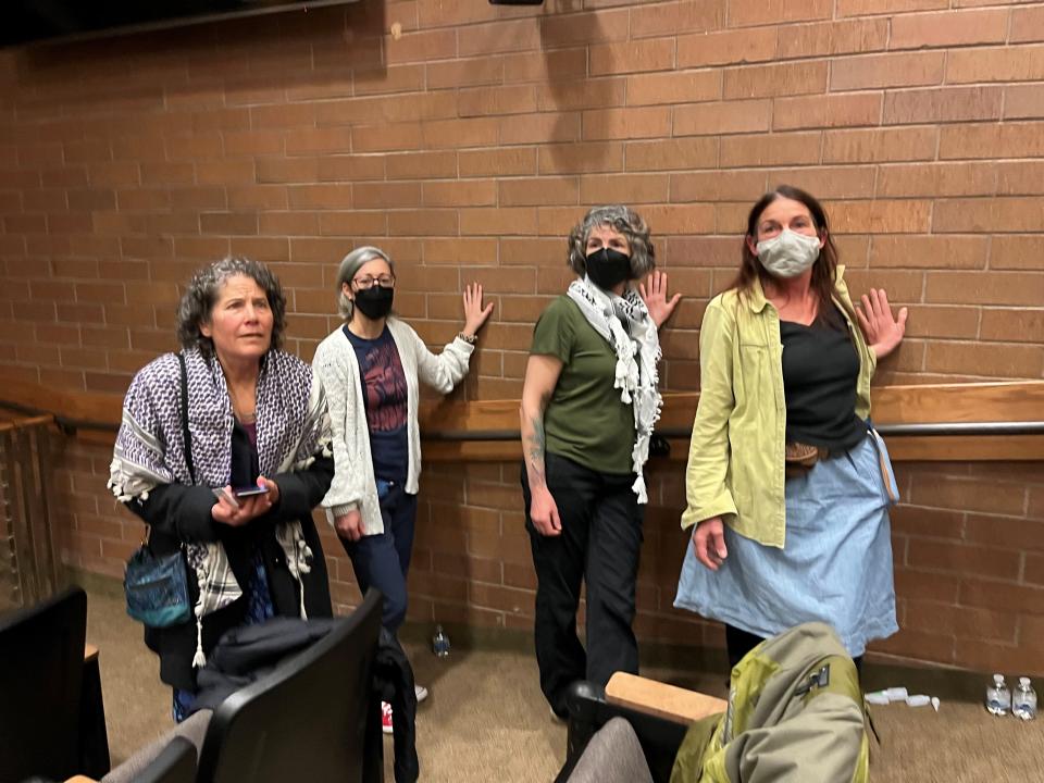 Claire Kopp, Hania Sakkal and Cheryl Distaso stand along the wall that they glued their hands to in protest Tuesday at Fort Collins City Hall. They were protesting City Council's declining to bring a resolution forward in support of a cease-fire in Gaza.