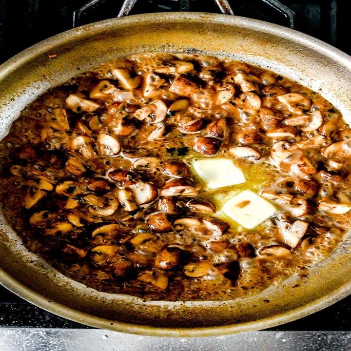 Mushrooms cooking in butter.