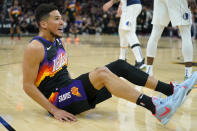 Phoenix Suns guard Devin Booker (1) looks for a foul call against the Dallas Mavericks during the first half of Game 7 of an NBA basketball Western Conference playoff semifinal, Sunday, May 15, 2022, in Phoenix. (AP Photo/Matt York)