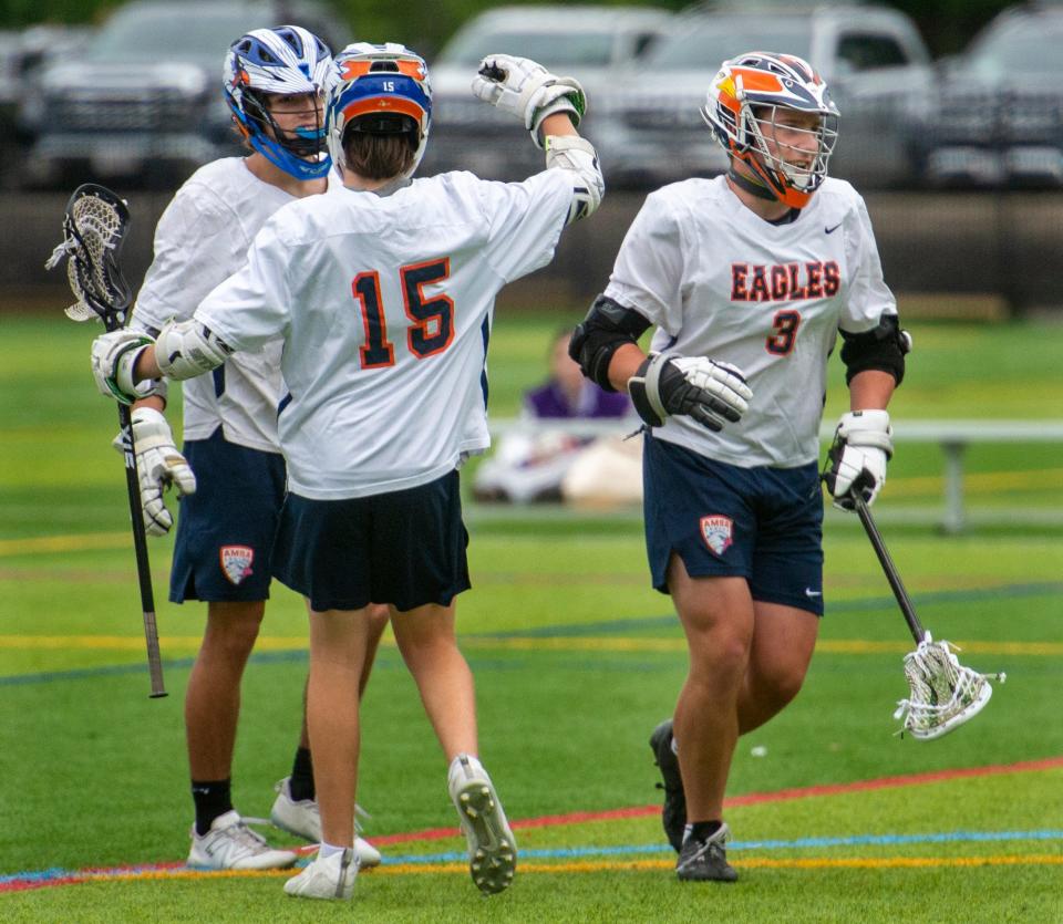 Advanced Math & Science Academy Charter School  (AMSA) lacrosse junior Casey Matijevic, of Marlborough, left, congratulated by junior Hayden Kearney, of Hudson, after scoring against Blackstone Valley Technical School (BVT) in a Round of 32 playoff game, June 5, 2023, at the Forekicks Sports Complex in Marlborough.  The goal came on an assist from  AMSA senior Patrick Andrews, right, of Marlborough, registering his 200th career point.