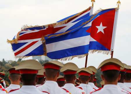 The Union Flag and Cuba's national flag flutter above a guard of honour as Britain's Prince Charles and Camilla, Duchess of Cornwall, arrive in Havana, Cuba, March 24, 2019. REUTERS/Phil Noble
