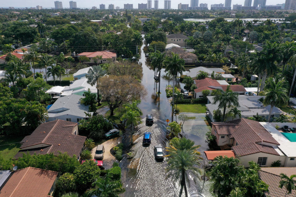 Cars navigate through flooded streets after record rains fell in Hollywood, Fla., on April 13, 2023.<span class="copyright">Joe Raedle—Getty Images</span>