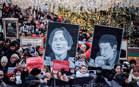 Russian opposition protesters march to commemorate the memories of lawyer Stanislav Markelov and journalist Anastasia Baburova - Credit: ALEXANDER NEMENOV/AFP via Getty Images