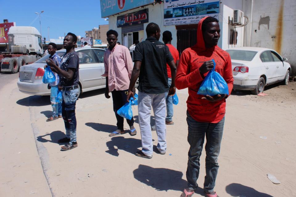 Migrants wait for food handouts in Misrata, Libya: REUTERS