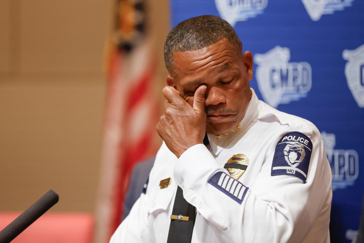 CMPD Chief Johnny Jennings wiping away tears at a press conference (AP)