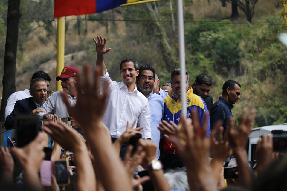 Opposition leader Juan Guaidó, who has declared himself Venezuela's interim president, waves to supporters during a rally in the Caracas district Caricuao, Venezuela, Wednesday, April 10, 2019. Vice President Mike Pence addressed the U.N. Security Council on Wednesday and urged the United Nations to recognize Guaidó as Venezuela's president in place of Nicolás Maduro and revoke the credentials of Venezuela's U.N. Ambassador Samuel Moncada, who was also seated at the council's horseshoe-shaped table.(AP Photo/Fernando Llano)