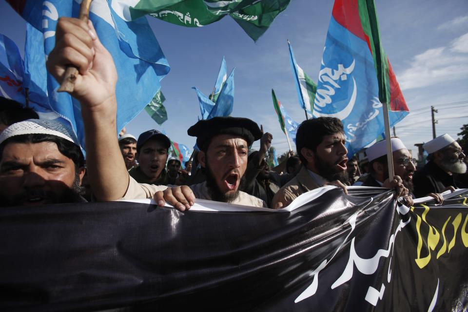 Supporters of Pakistani political and religious party Jamat-e-Islami chant slogans as they protest in Peshawar