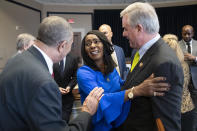 Rep. William Lacy Clay, D-Mo., left, and Rep. David Trone, D-Md., right, talk with Judy Pace Flood, after a news conference as they call for the late Curt Flood to be inducted into the Baseball Hall of Fame, on Capitol Hill, Thursday, Feb. 27, 2020 in Washington. (AP Photo/Alex Brandon)