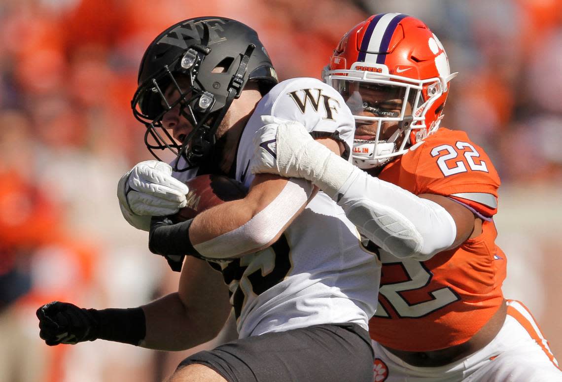 Clemson linebacker Trenton Simpson (22) wraps up Wake Forest wide receiver Taylor Morin (83) during first-quarter action in Clemson, S.C. on Saturday.