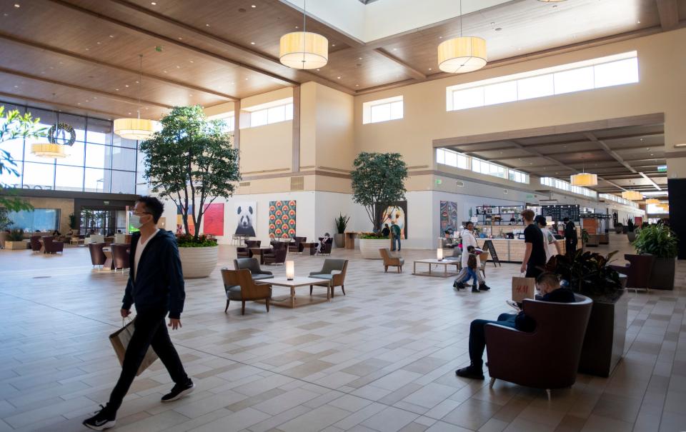 Patrons walk through the Foothills mall in Fort Collins, Colo. on Friday, Jan. 8, 2021.