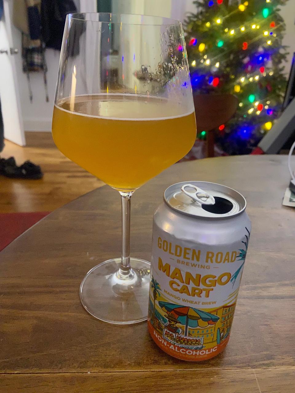 Mango Cart nonalcoholic beer can and glass