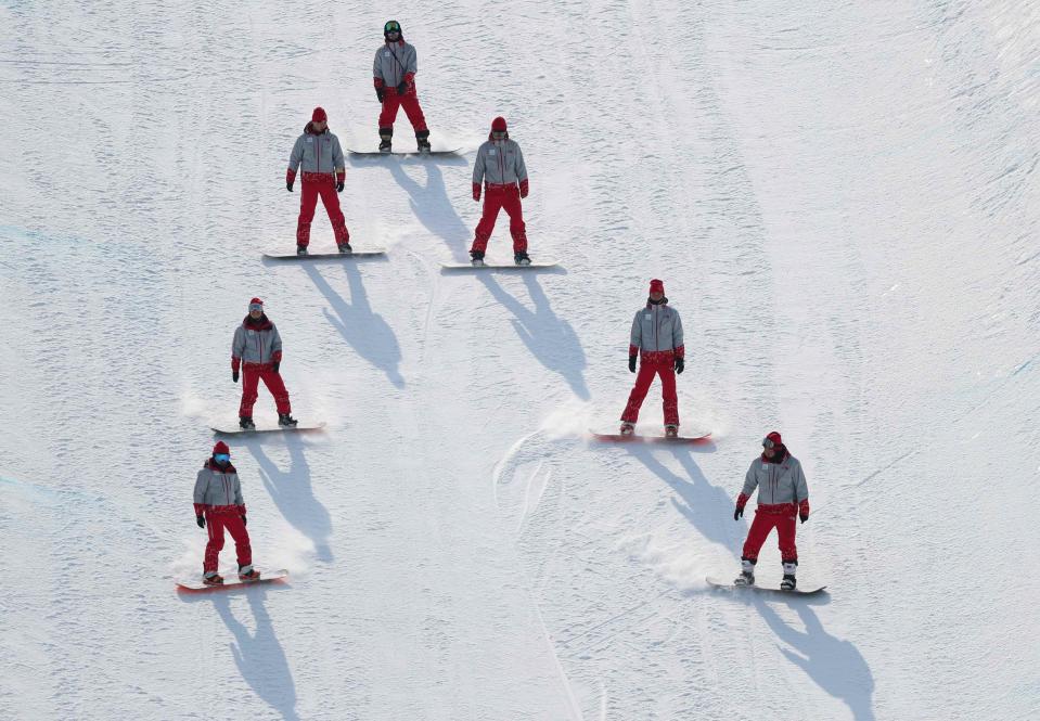 <p>Workers fix the slope after Joel Gisler of Switzerland crashed. REUTERS/Mike Blake </p>