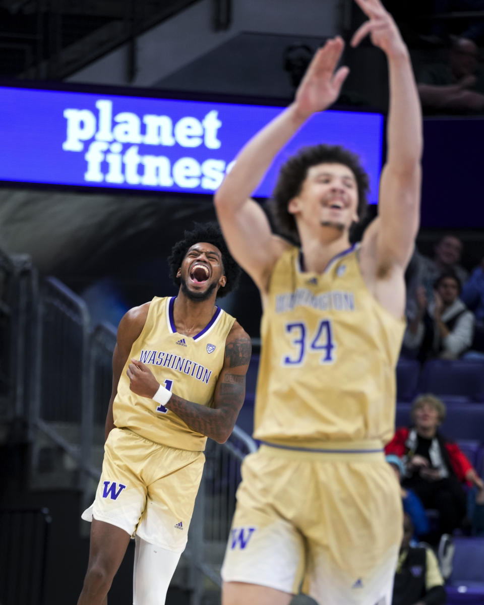 Washington forward Keion Brooks Jr., back, and center Braxton Meah (34) celebrate after a basket against Arizona State during the second half of an NCAA college basketball game Thursday, Jan. 11, 2024, in Seattle. (AP Photo/Lindsey Wasson)