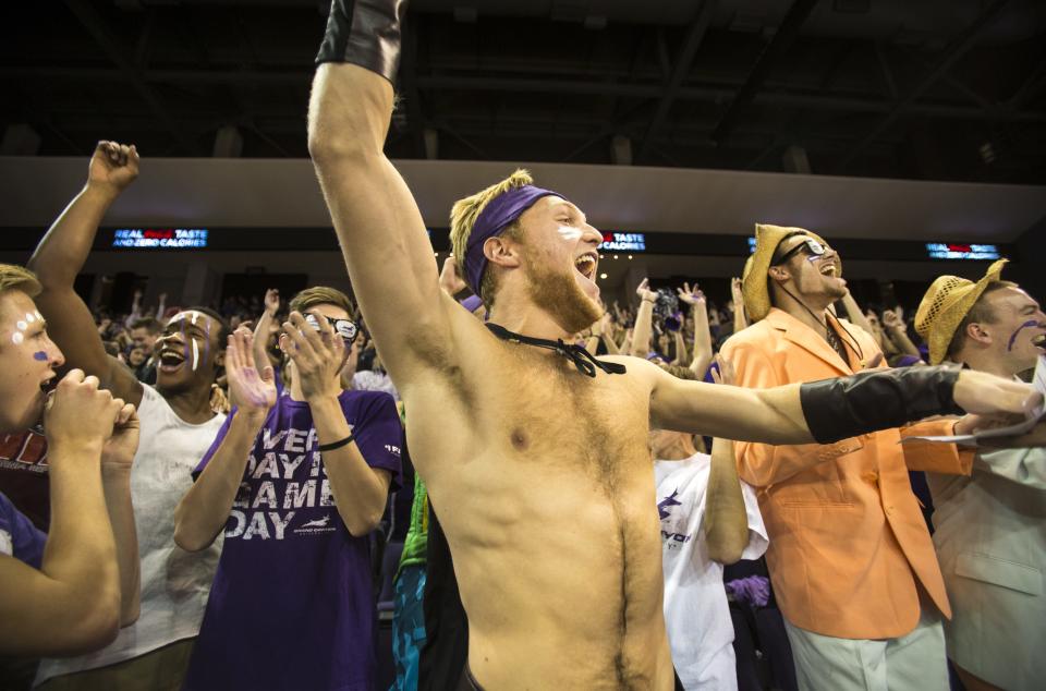 Sophomore Brandon Kaiser (center) and others react to a GCU slam dunk as the Grand Canyon University men's basketball team takes on Utah Valley University at home on Feb. 6, 2014. GCU lost 79-68.