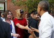 RNPS - REUTERS NEWS PICTURE SERVICE - PICTURES OF THE YEAR 2014 - ODDLY U.S. President Barack Obama greets a man wearing a horse mask during a walkabout in Denver in this July 8, 2014 file photo. REUTERS/Kevin Lamarque/Files (UNITED STATES - Tags: POLITICS ANIMALS TPX IMAGES OF THE DAY)