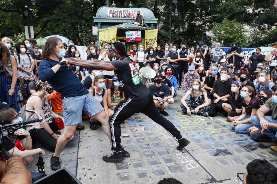 Protesters learn defensive tactics during a demonstration at an encampment outside City Hall, Tuesday, June 30, 2020, in New York. New York City lawmakers are holding a high-stakes debate on the city budget as activists demand a $1 billion shift from policing to social services and the city grapples with multibillion-dollar losses because of the coronavirus pandemic. (AP Photo/John Minchillo)
