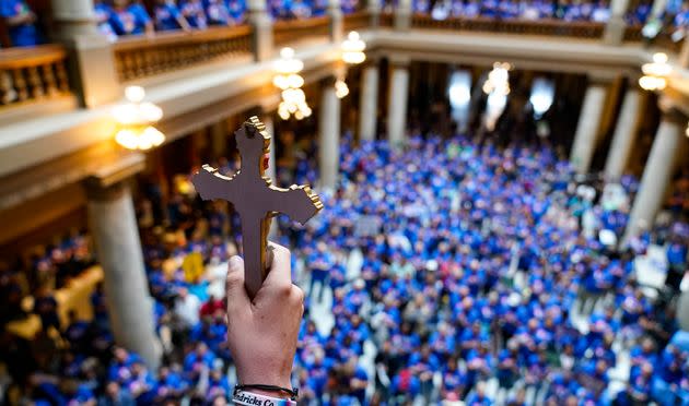 An anti-abortion advocate holds a crucifix up as anti-abortion supporters rally at the Indiana State Capitol ahead of the legislature debating a proposal to ban nearly all abortions in the state. (Photo: Michael Conroy/Associated Press)
