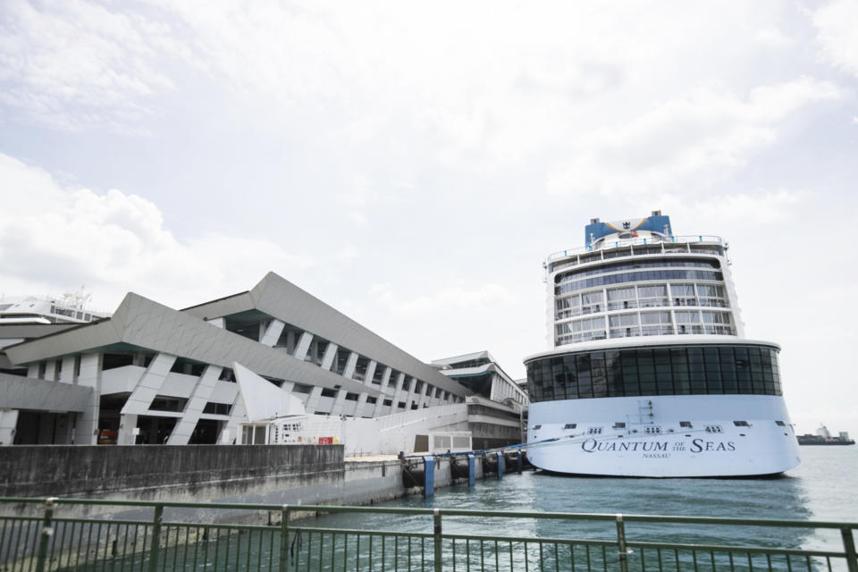 The Quantum of the Seas cruise ship is docked at the Marina Bay Cruise Center Wednesday, Dec. 9, 2020 in Singapore. Royal Caribbean said in a statement that a guest on the Quantum of the Seas “tested positive for coronavirus after checking in with our medical team." The ship returned to port in accordance with government protocols. (AP Photo/Danial Hakim)