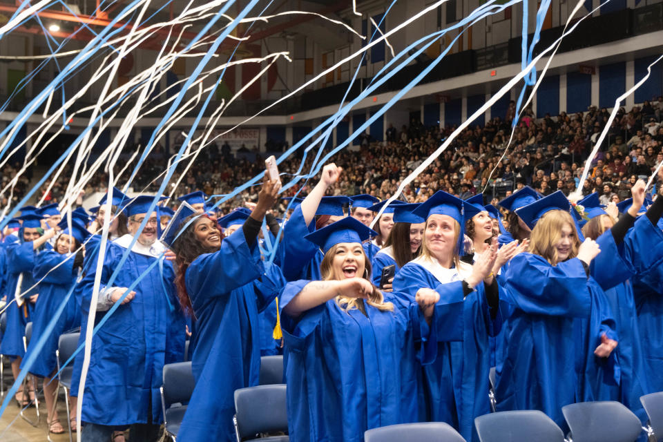 Graduates celebrate as streamers rain down upon them Friday evening at the Amarillo College Commencement Ceremony at the Amarillo Civic Center.