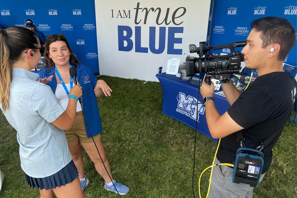 Middle Tennessee State University Aerospace Pro Pilot graduate Bri McDonald, outreach coordinator for the MTSU Aerospace Department, leads a crew from FLYING Magazine’s TV show “Oshkosh Live” on a tour of MTSU’s tent at the 2024 EAA AirVenture, held annually in Oshkosh, Wisconsin.