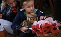 A young boy is pictured with a teddy bear after the dawn service at Sydney's Dee Why beach. Source: Robert Peacock.