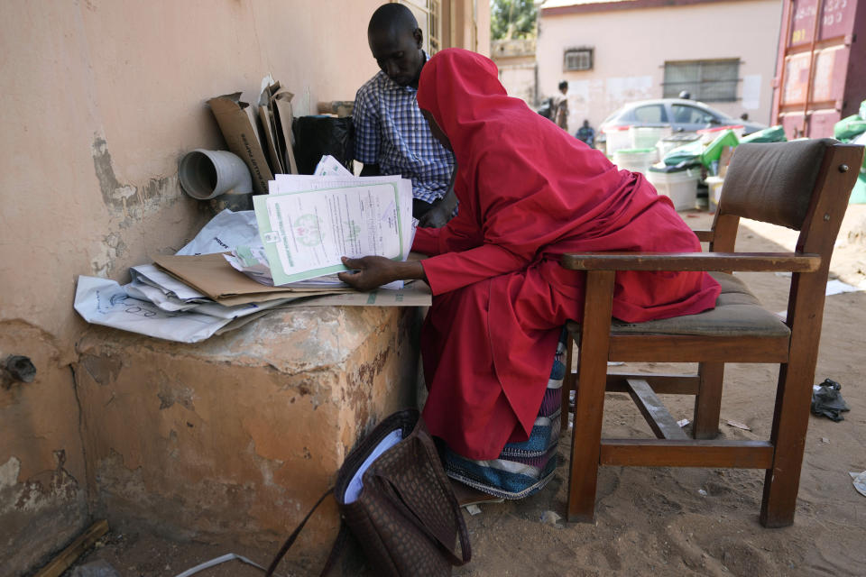 Electoral officials gather election documents, at the Local Independent National Electoral Commission office in Yola, Nigeria Sunday, Feb. 26, 2023. People are still voting across Nigeria, one day after Africa’s most populous nation went to the polls to vote for presidential and parliamentary elections. Votes are being cast in Benue, Adamawa and Bayelsa states, while ballots are being tallied in places where voting is complete, with preliminary results expected as early as Sunday evening. (AP Photo/Sunday Alamba)