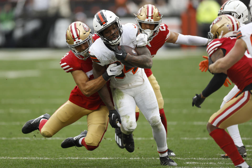 Cleveland Browns running back Jerome Ford, middle, is tackled by San Francisco 49ers safety Talanoa Hufanga during the second half of an NFL football game Sunday, Oct. 15, 2023, in Cleveland. (AP Photo/Ron Schwane)