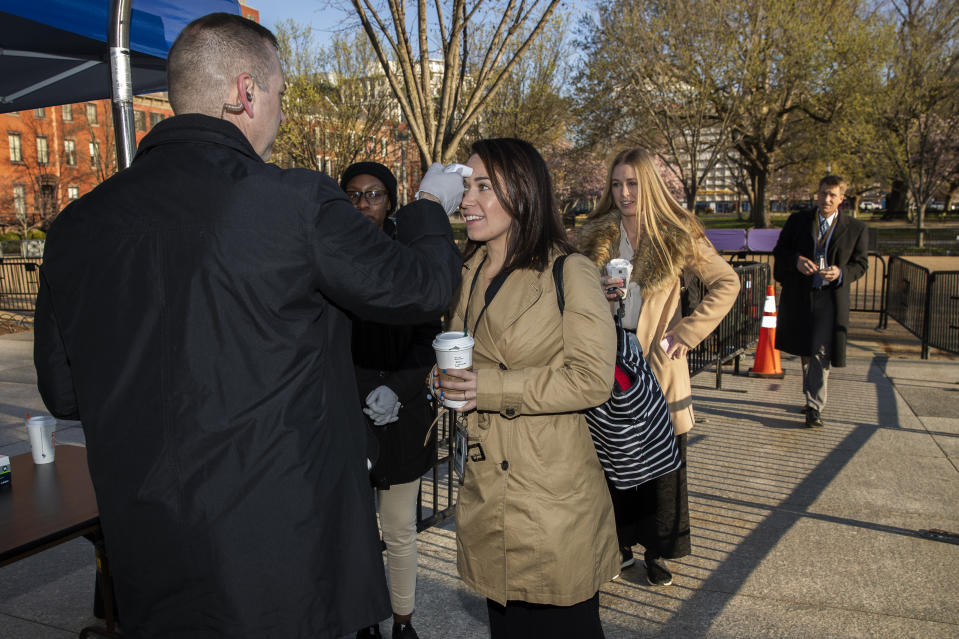 Journalists and White House staff's body temperature are checked by White House medical staff before they enter the White House perimeter, Monday, March 16, 2020, in Washington. (AP Photo/Manuel Balce Ceneta)