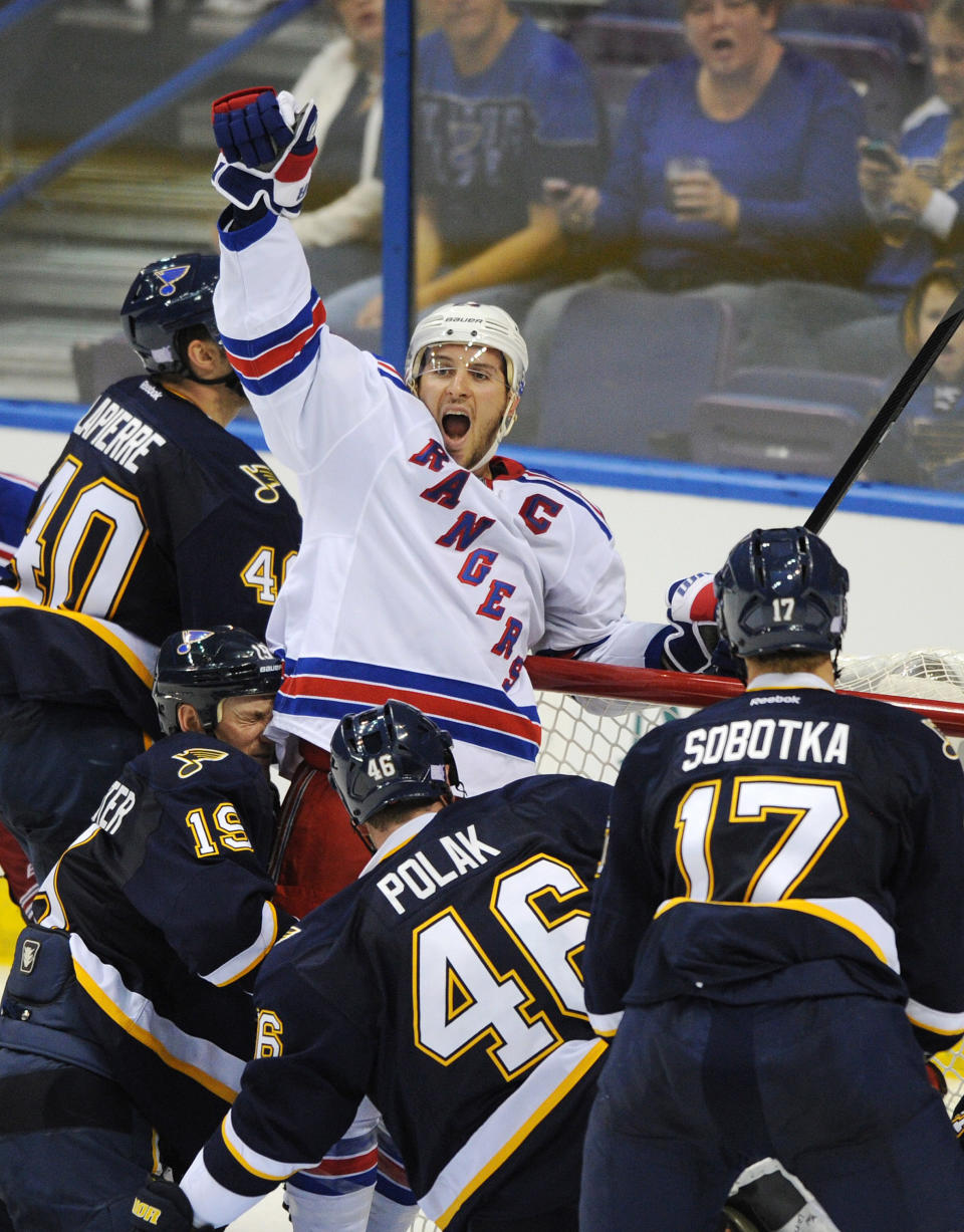 FILE - In this Oct. 12, 2013 file photo, New York Rangers' Ryan Callahan, center, celebrates his goal as St. Louis Blues' Vladimir Sobotka (17), of the Czech Republic, Roman Polak (46), also of the Czech Republic, Jay Bouwmeester (19) and Maxim Lapierre (40) defend during the third period of an NHL hockey game in St. Louis. The Rangers and Tampa Bay Lightning are pulling off the first major deal on NHL trade deadline day, Wednesday, March 5, 2014, swapping captains Ryan Callahan and Martin St. Louis. (AP Photo/Bill Boyce, File)