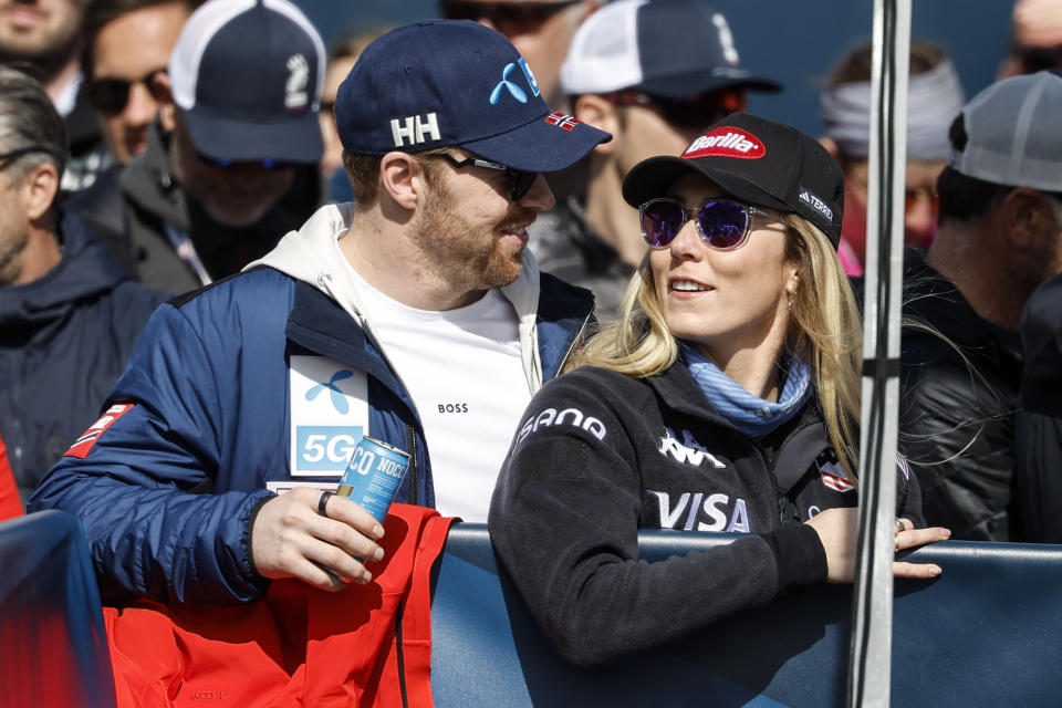 FILE - United States' Mikaela Shiffrin, right, and Norway's Aleksander Aamodt Kilde stand in the finish area and follow an alpine ski women's World Cup downhill, in Saalbach, Austria, on March 23, 2024. Skiing power couple Mikaela Shiffrin and Aleksander Aamodt Kilde have announced they’re engaged to be married. Shiffrin, a two-time Olympic champion who has won a record 97 World Cup races, holds her ring up to the camera in one of several photos they posted on their social media accounts. Aamodt Kilde is a former overall World Cup champion and two-time Olympic medalist. (AP Photo/Alessandro Trovati, File)