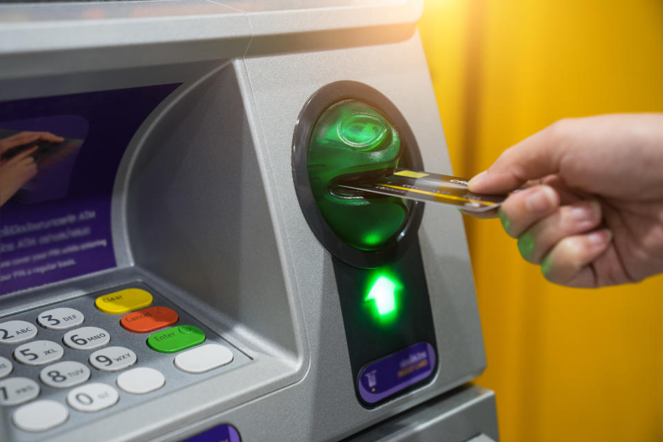 Person putting their card into an ATM