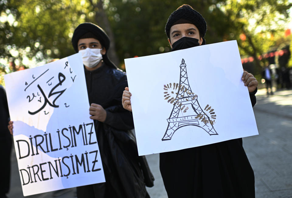 Protesters hold placards with a depiction of Eiffel Tower in Paris, right, marked with a shoe stamp a sign of disrespect, and one, left, with a slogan reading in Turkish: ""Our resurrection, our resistance" , during a protest by members of Islamic groups against France in Istanbul, Sunday, Nov. 1, 2020. There had been tension between France and Turkey after Turkish President Recep Tayyip Erdogan said France's President Emmanuel Macron needed mental health treatment and made other comments that the French government described as unacceptably rude. Erdogan questioned his French counterpart's mental condition while criticizing Macron's attitude toward Islam and Muslims. (AP Photo)