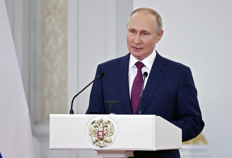 Russian President Vladimir Putin attends a meeting with the country's Olympic athletes in Moscow