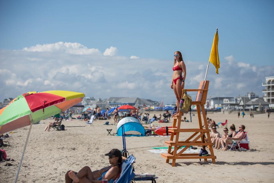 Hampton Beach lifeguard Claire Rademacher stands guard on a relatively quiet day at Hamtpon Beach Saturday, Aug. 21, 2021.