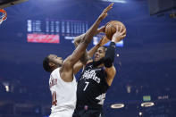 Los Angeles Clippers guard Amir Coffey (7) shoots against Cleveland Cavaliers forward Evan Mobley (4) during the first half of an NBA basketball game, Sunday, Jan. 29, 2023, in Cleveland. (AP Photo/Ron Schwane)