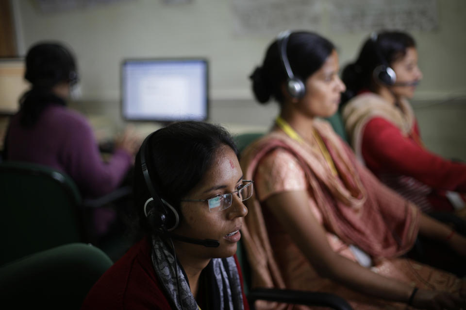 In this Aug. 23, 2012 photo, employees use headsets as they work on computers at the B2R center in Simayal, India. Before B2R arrived in Simayal, local women had little option but to marry right out of school, and educated young men had to travel far to seek respectable jobs. (AP Photo/Saurabh Das)