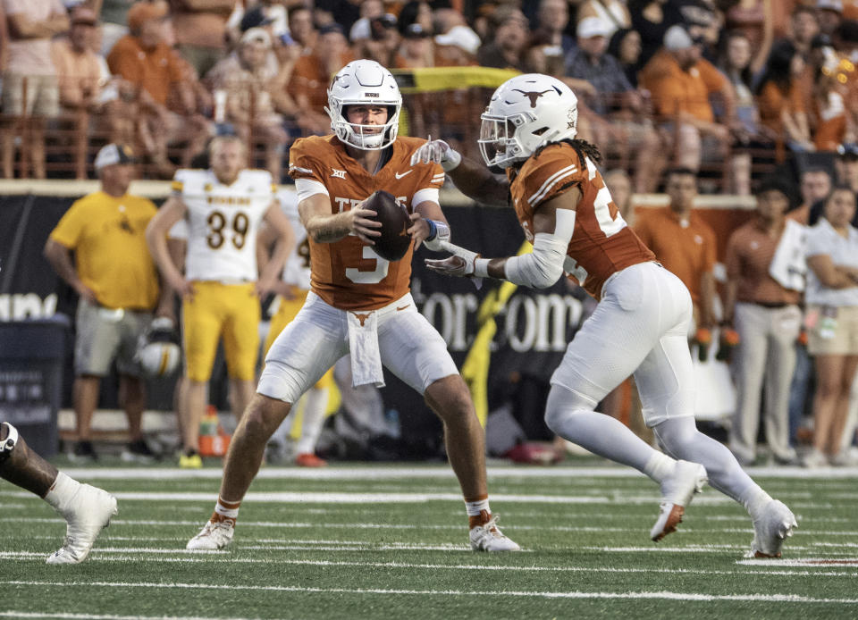 Texas quarterback Quinn Ewers hands the ball off to running back Jonathon Brooks during the first half of the team's NCAA college football game against Wyoming, Saturday, Sept. 16, 2023, in Austin, Texas. (AP Photo/Michael Thomas)
