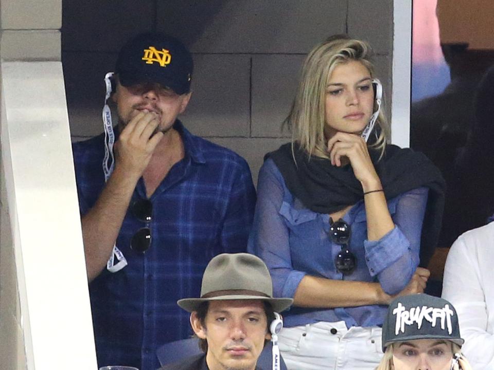 Leonardo DiCaprio and Kelly Rohrbach take in a match at the US Open in 2015.