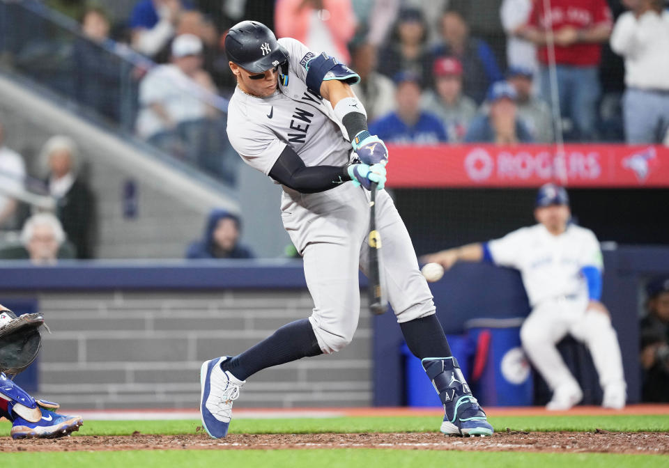 Apr 17, 2024; Toronto, Ontario, CAN; New York Yankees centre fielder Aaron Judge (99) hits a two run single against the Toronto Blue Jays during the ninth inning at Rogers Centre. Mandatory Credit: Nick Turchiaro-USA TODAY Sports